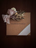 Gift box with floral arrangement and 'Flower & Fable' branding on a dark background