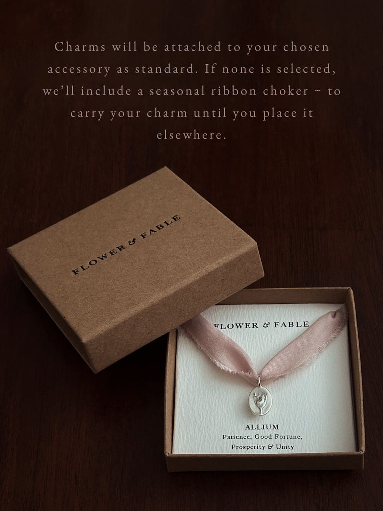 Flower charm packaged with a seasonal ribbon 