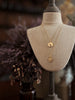 Gold plated sterling silver coin charm pendants on a vintage bust with belcher chain necklaces