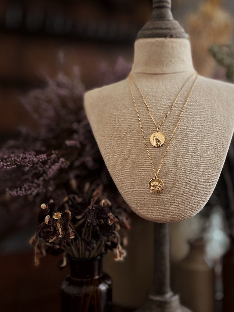Gold plated sterling silver coin charm pendants on a vintage bust with belcher chain necklaces