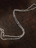 Curb satellite necklace chain sterling silver on a dark background