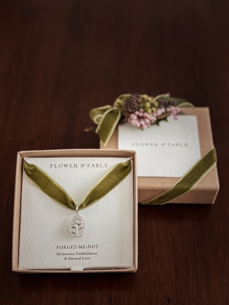 Jewellery box with a necklace and card, featuring 'Flower & Fable' branding.