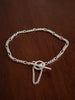 Silver figaro chain bracelet with a safety chain