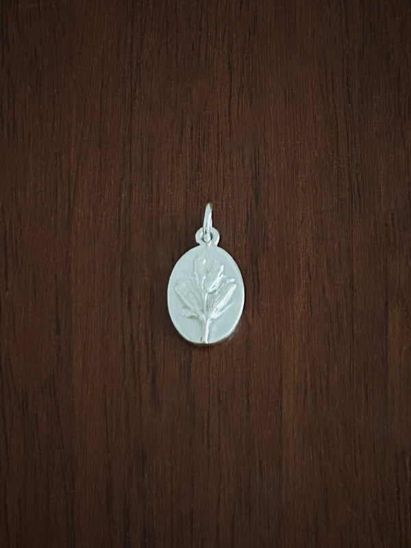 Sterling Silver lavender pendant on a wooden surface
