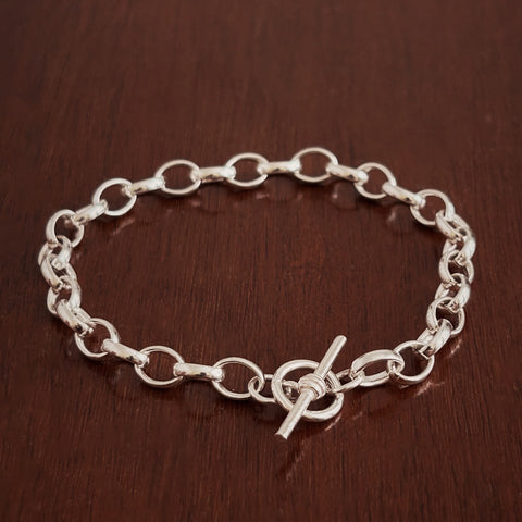 Sterling Silver Belcher chain bracelet on a wooden surface