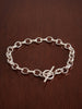 Sterling Silver Belcher chain bracelet on a wooden surface