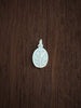 Silver thyme pendant for courage on a wooden surface