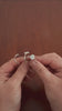 Three sterling silver signet rings, with fern, gypsophila and herb robert flowers being moved in hands.